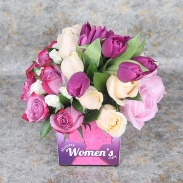 Happy Women's Day Flowers Arrangements, Purple Tulips, Deep Purple Roses, Peach Roses, Pink Roses, White Baby Roses, Single Ruscus, Square Glass Vase, Women's Day Stickers